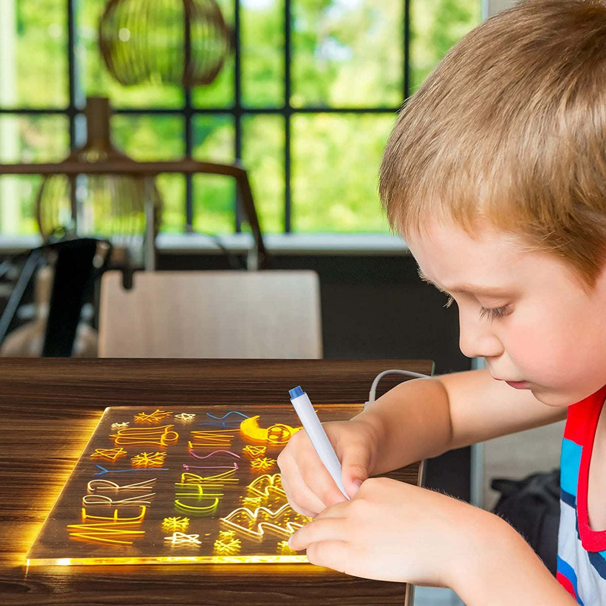 Child drawing on the 3D Acrylic Writing Pad LED Lamp